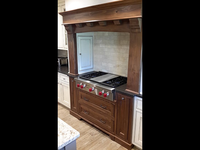 Knotty Alder Mantle style range hood and cabinets